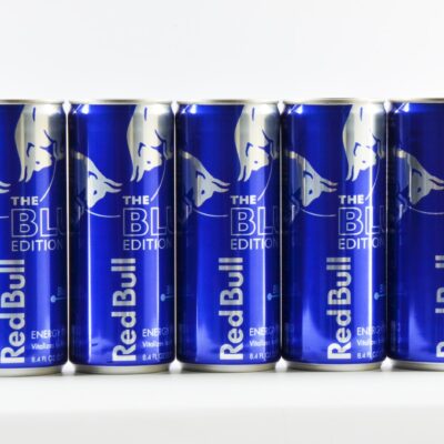 six cans of red bull energy drink lined up